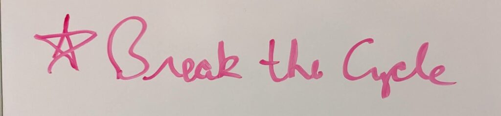 Writing on a whiteboard that has a 5-point star and the words "Break the Cycle".